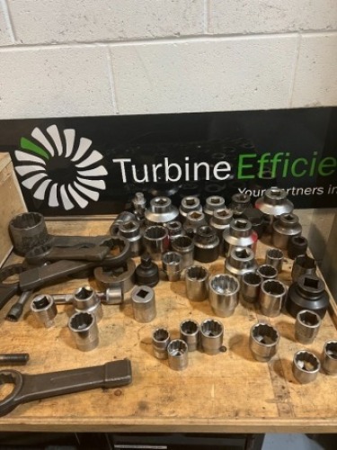Quantity of various hand tools to inlcude large wrenches and sockets to table top