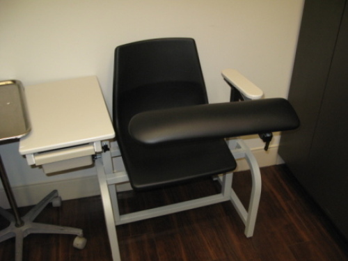 Room D102 Phlebotomy Room; Patient Phlebotomy Chair; Suntech ADC BP/Oxygen/Temp/Pulse Monitor on Stand, Model # not visible; Health-O-Meter Professional Digital Floor Scale, Model #500KL; Wall Art; Stool on wheels